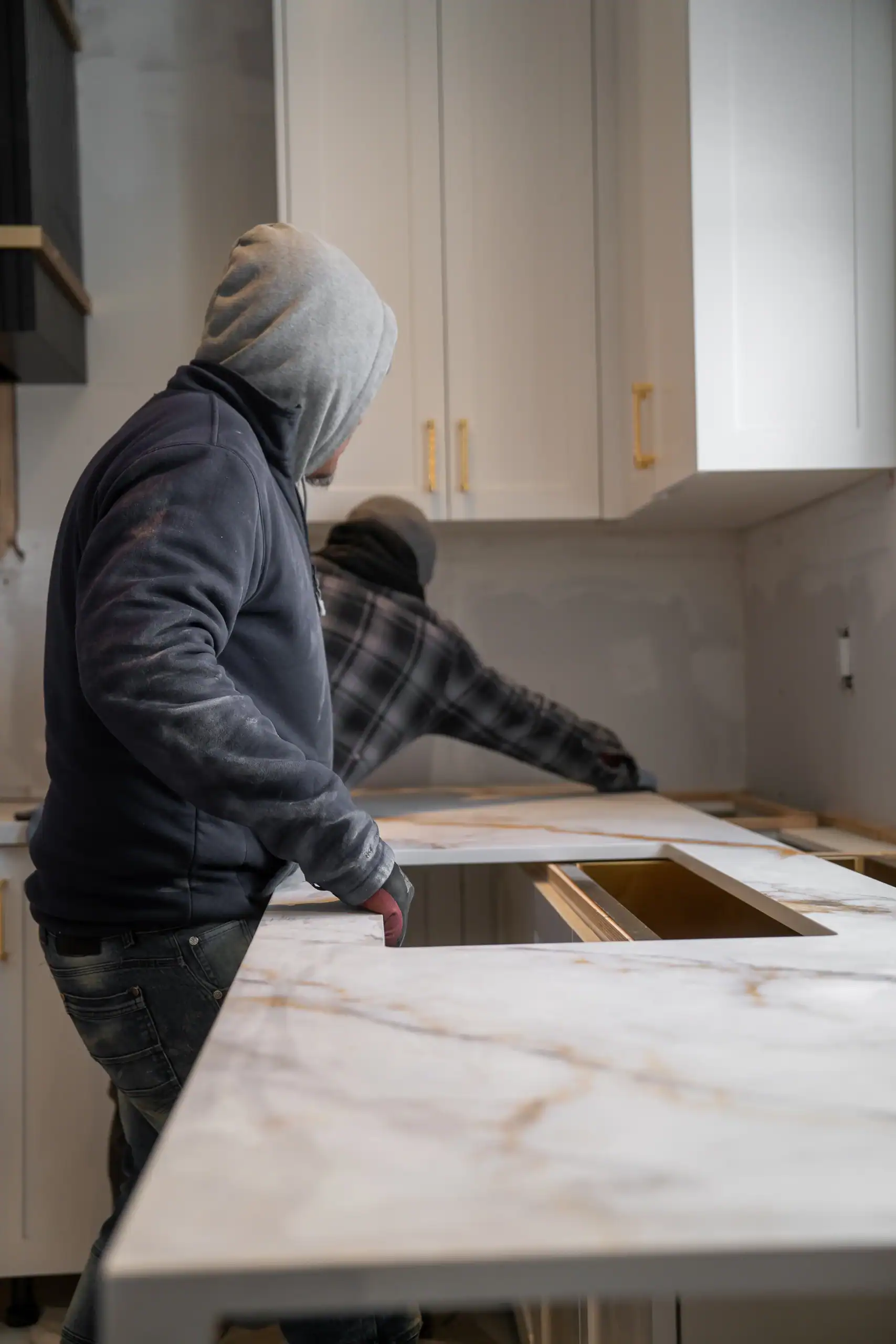 Stone Valley Countertops installers positioning a quartz kitchen countertop during installation in Ontario