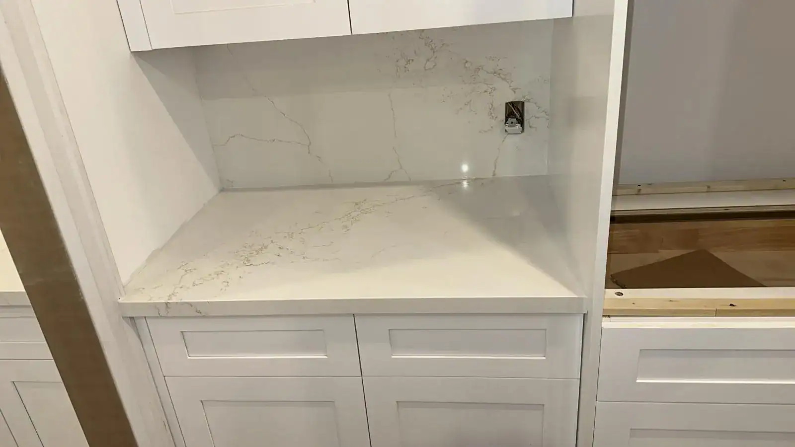Close-up of mitered edge quartz countertop with full height backsplash in a modern Ontario kitchen
