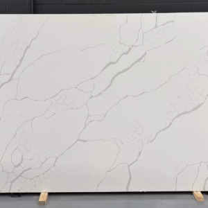 White quartz slab with bold gray veining and unique geometric patterns resembling cracked stone