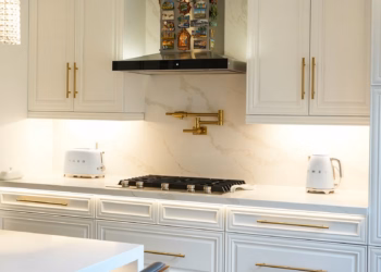 Side-angle view of a Calacatta Oro quartz kitchen countertop featuring elegant gold veining and a polished finish.
