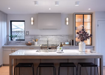 Angled view of a modern kitchen with HanStone Matterhorn quartz countertops and island installed by Stone Valley Countertops.
