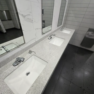 Long quartz sink countertop installation for commercial restroom at OnRoute Port Hope Ontario