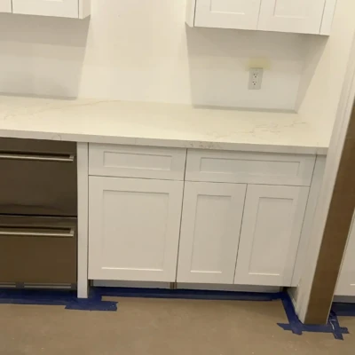 Quartz kitchen countertops installed around mini fridge and cabinetry in Bewdley Ontario